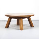 Large rustic vintage coffee table in a round brutalist style.