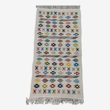 White carpet with multicolored hand-woven Berber patterns