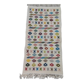 White carpet with multicolored hand-woven Berber patterns