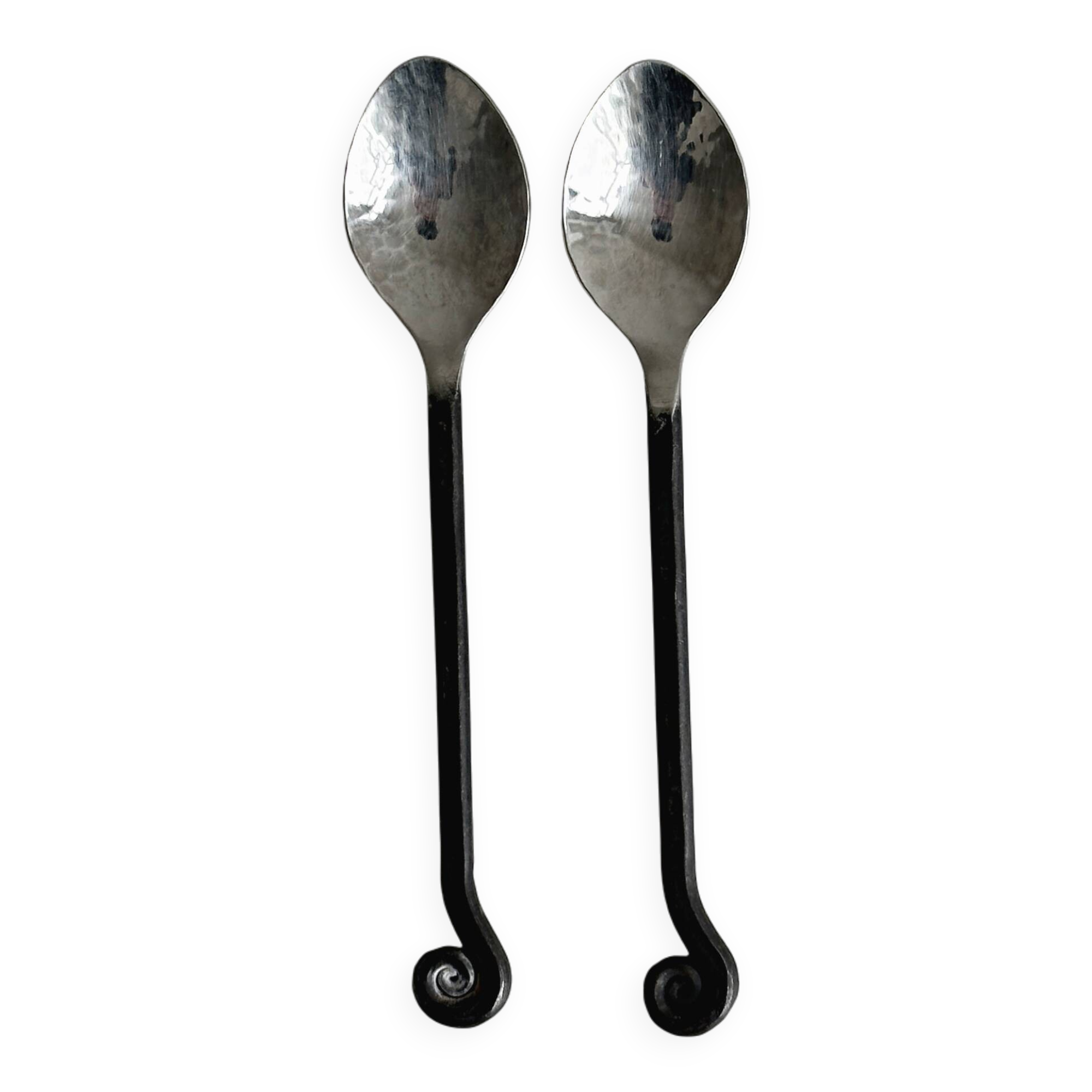 Two small hammered metal teaspoons with a snail pattern.