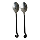 Two small hammered metal teaspoons with a snail pattern.