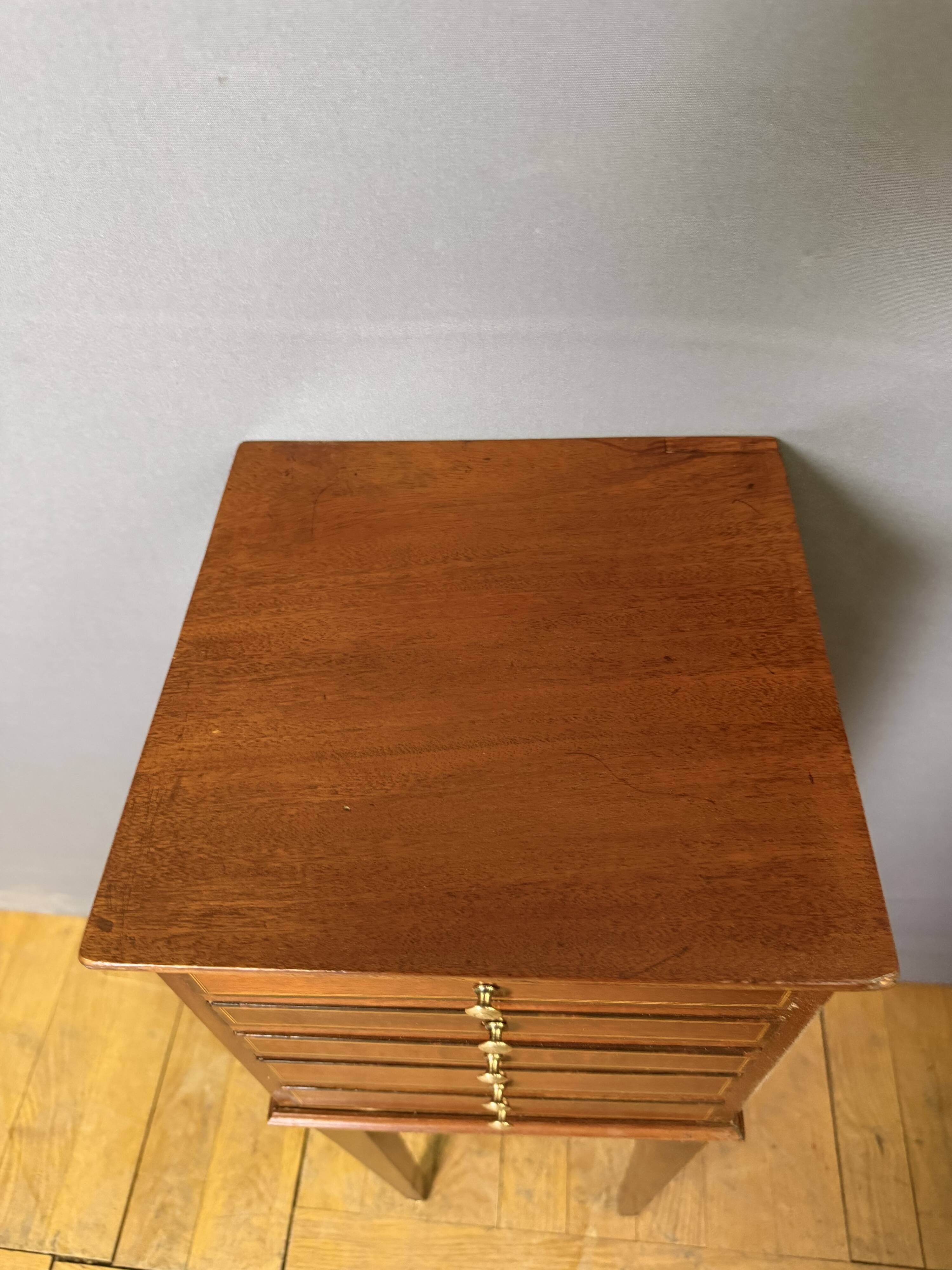 Louis XVI bedside table in mahogany with five drawers.