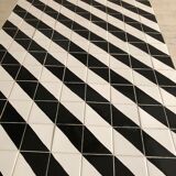 Iron table with top in black and white ceramic tiles