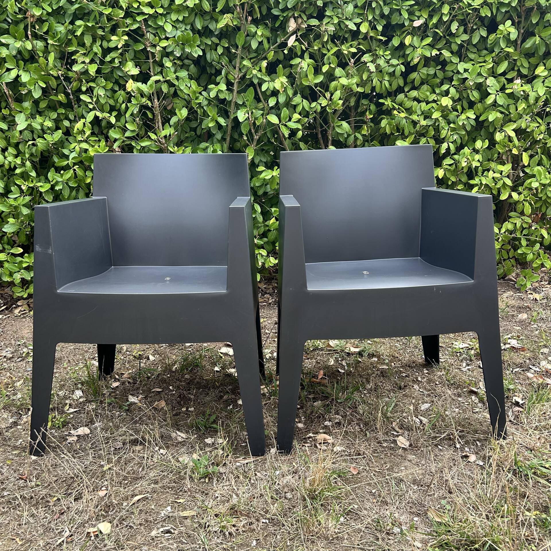 2 black Toy chairs designed by Starck