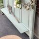 Cloakroom with sage green wall coats