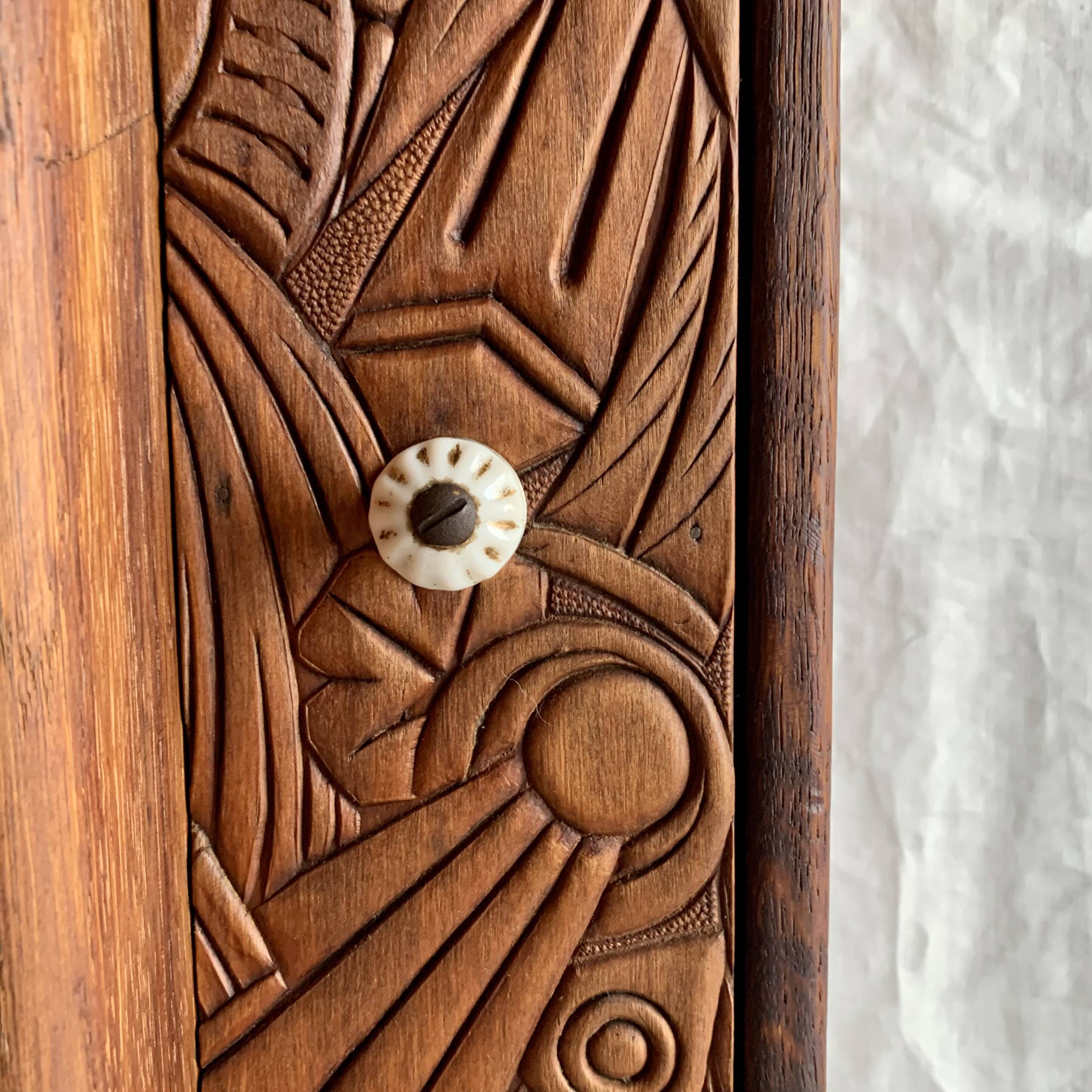 Old carved wooden medicine cabinet with beveled mirror