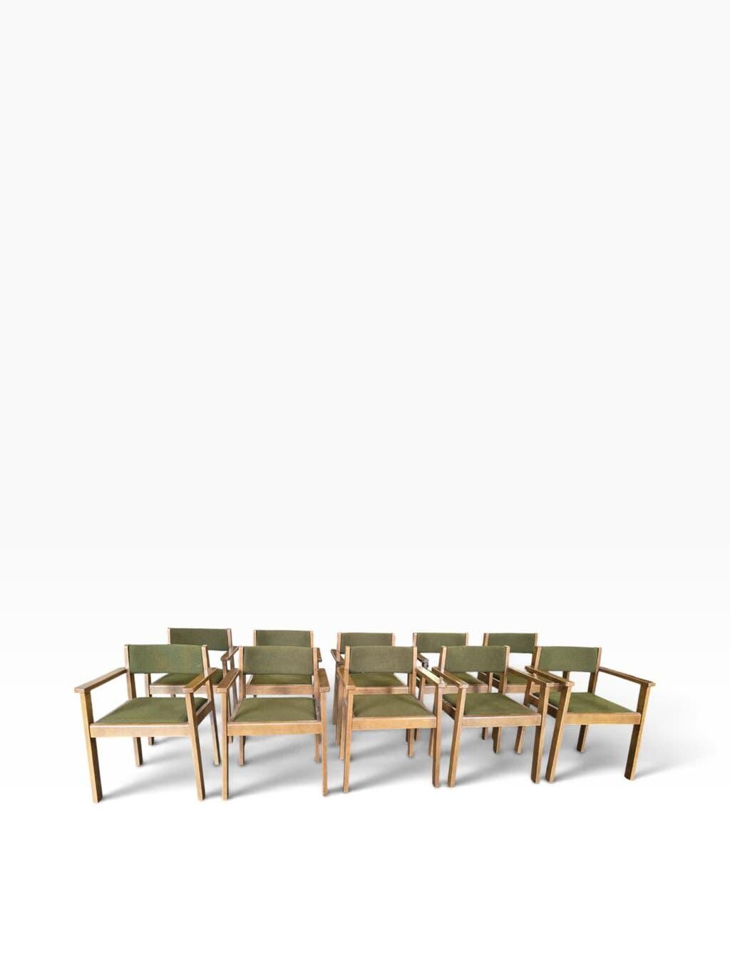 Vintage wooden chair with olive green seat and armrests.