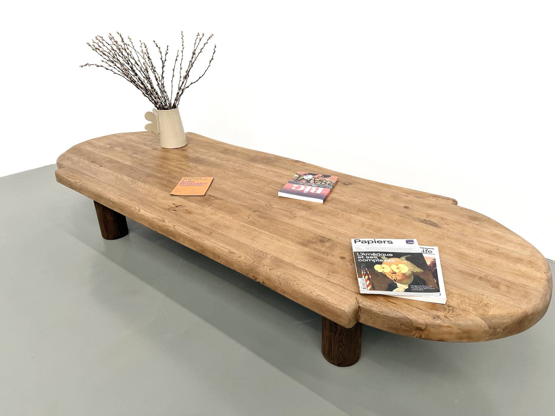 XXL oval coffee table in solid oak, cylindrical base, 1950s.