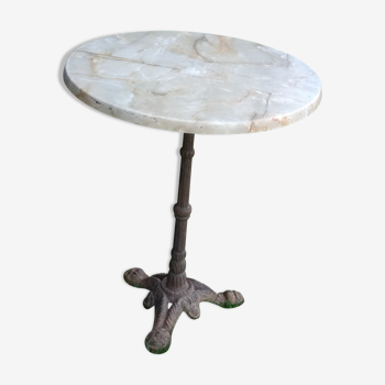 Old bistro table in cast-iron footing