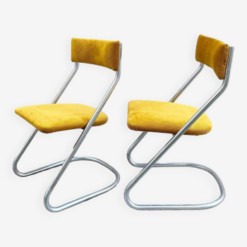 Pair of chrome cantilevered chairs with yellow corduroy seat