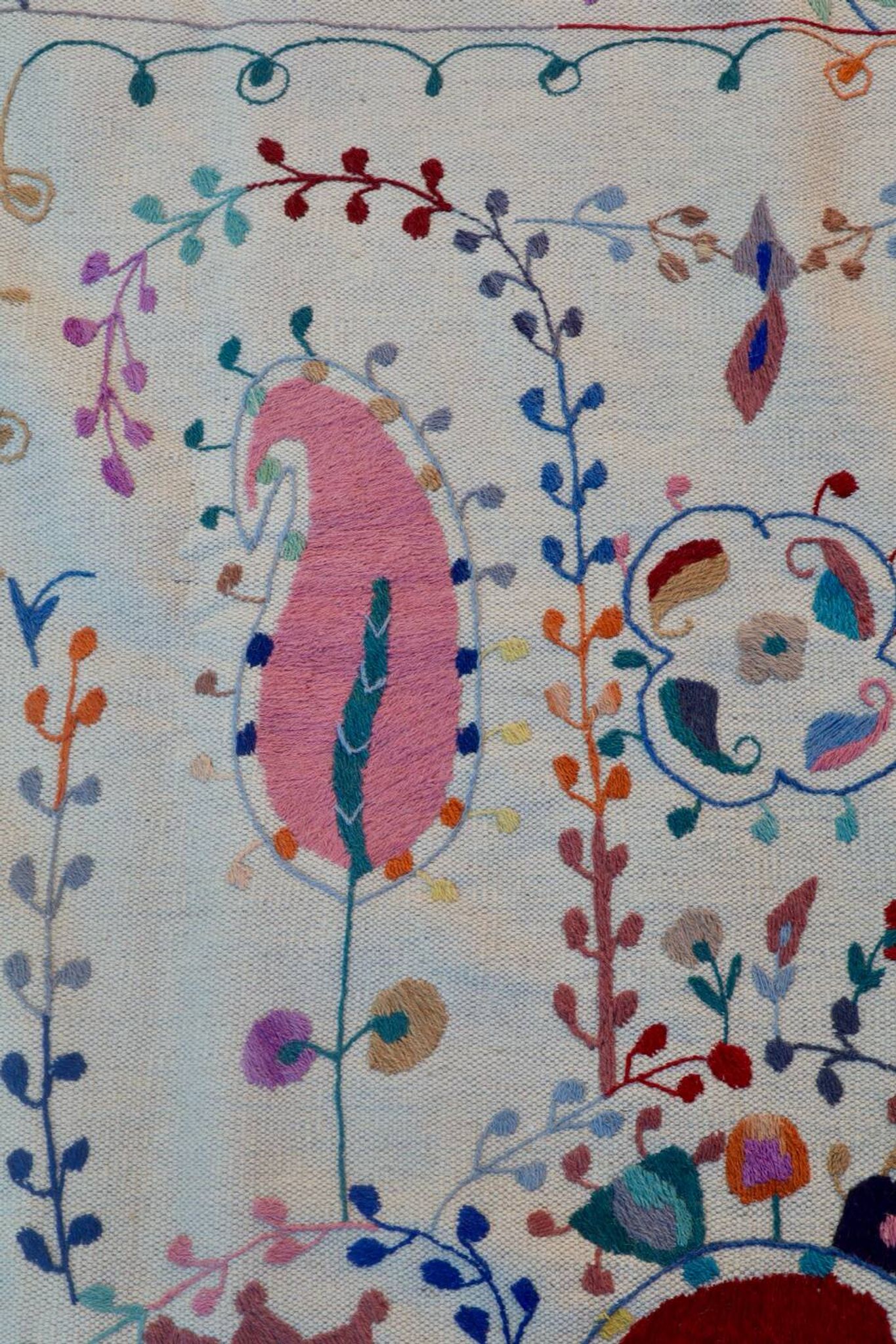 White suzani kilim rug with hand embroidered multi-colored patterns