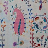 White suzani kilim rug with hand embroidered multi-colored patterns