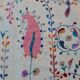 White suzani kilim rug with hand embroidered multi-colored patterns