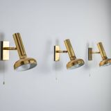 Set of three brass adjustable wall lamps