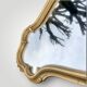 Ancien miroir mural en résine dorée style rococo
