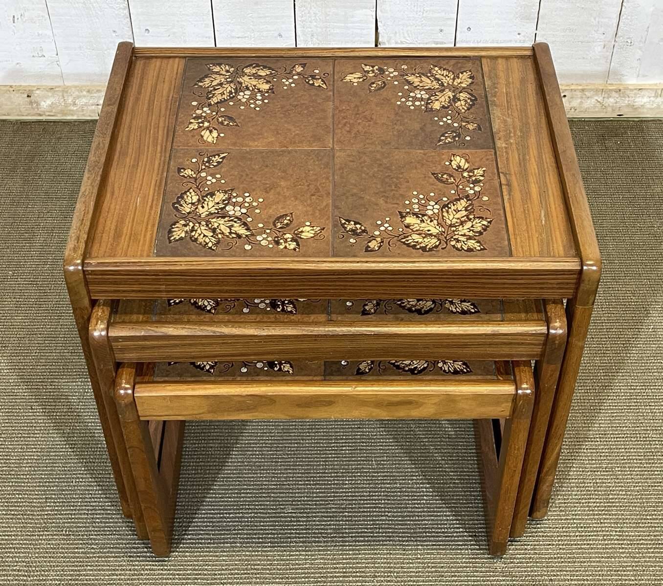Set of 3 nesting tables in teak with tiled tops.