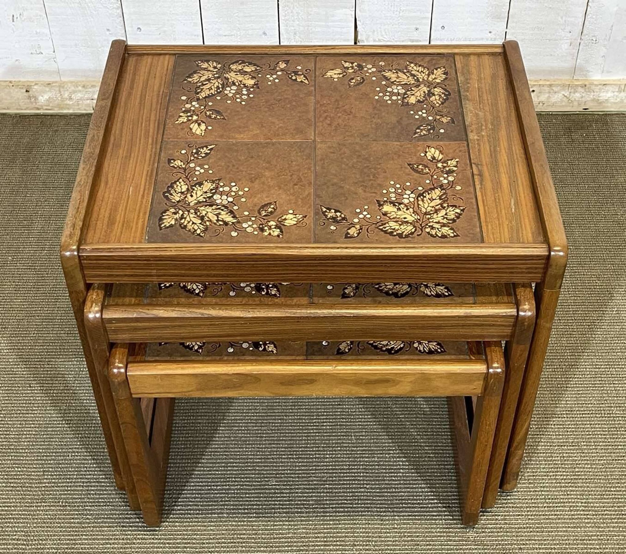 Set of 3 nesting tables in teak with tiled tops.