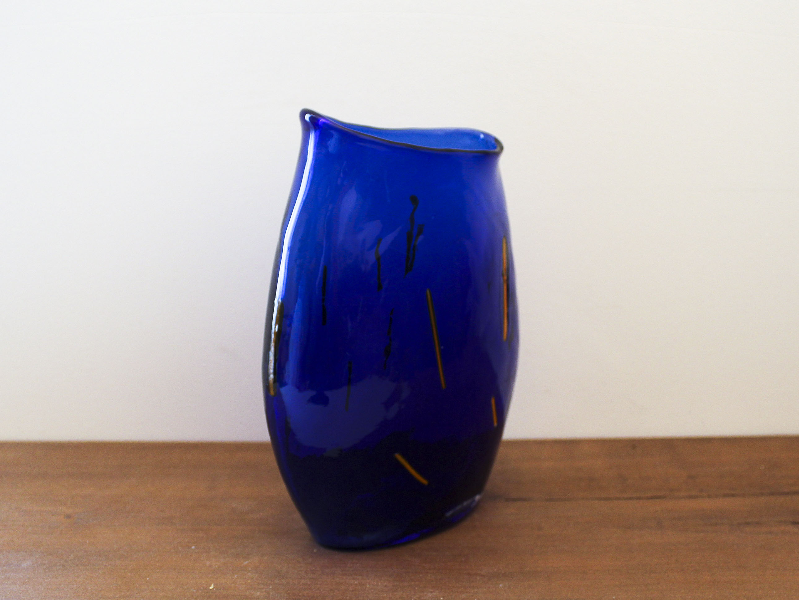 Blue blown glass vase and orange inclusion