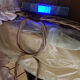 1960s wicker cradle with mattress and drapes.