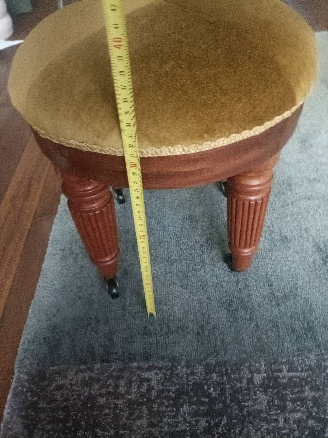 Upholstered stool on casters