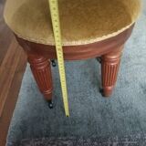Upholstered stool on casters