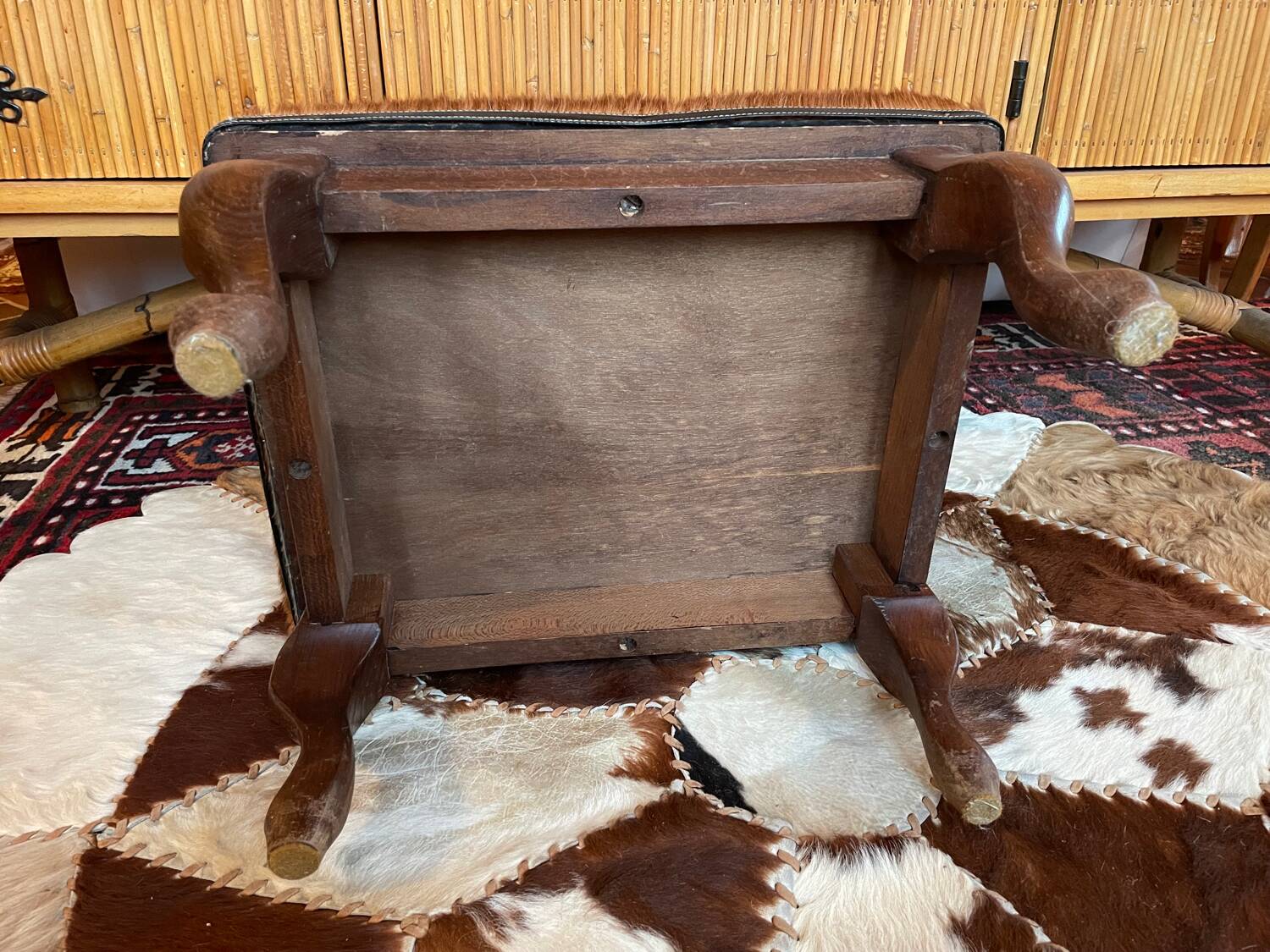Vintage wooden and goatskin pouf