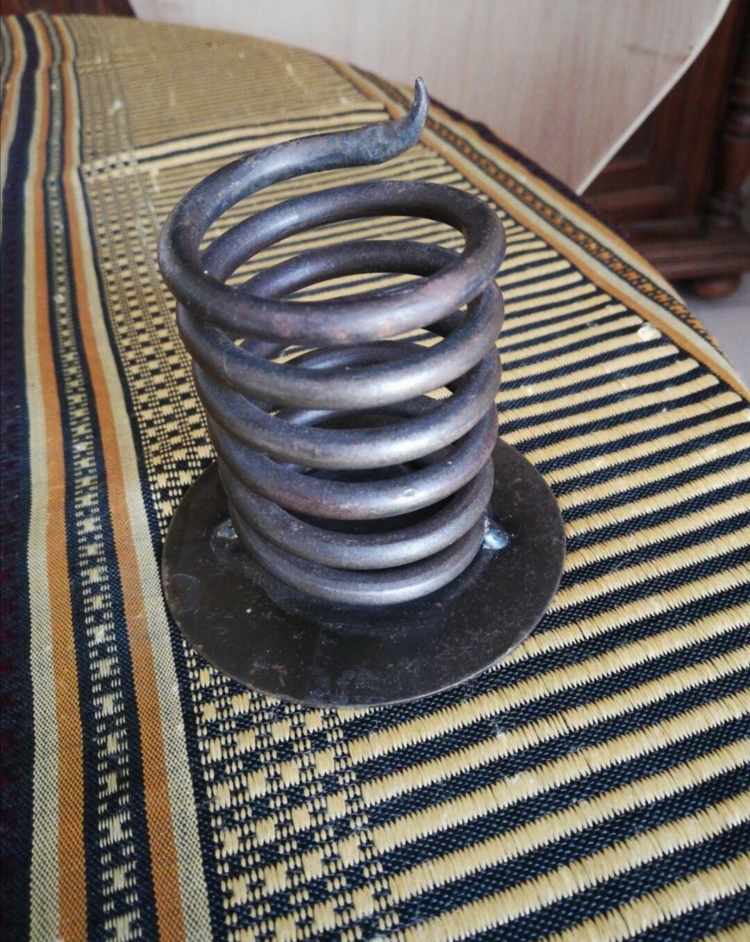 Spiral metal candle holder spring with candle, bronze appearance