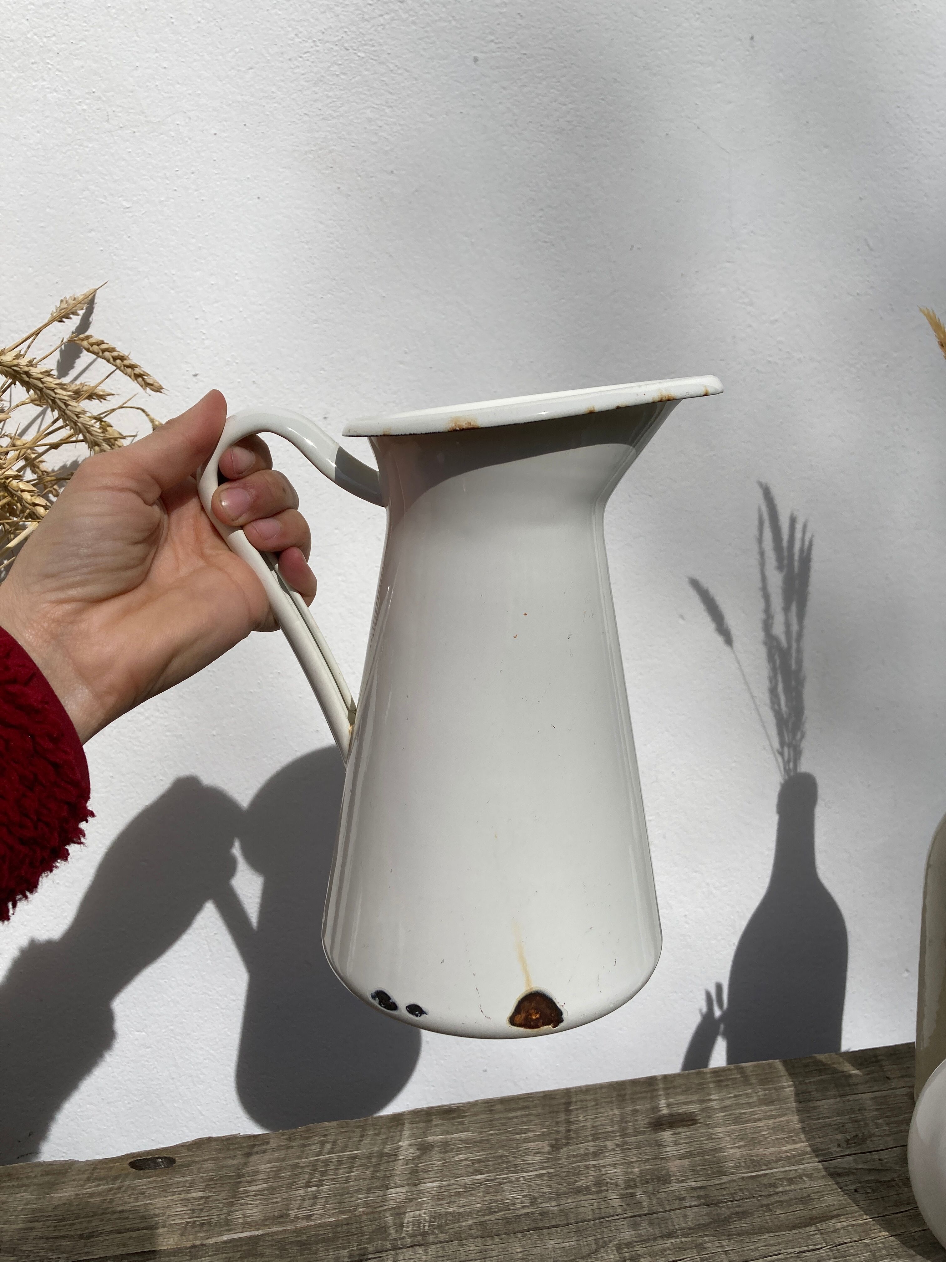Old white enamelled metal pitcher