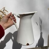 Old white enamelled metal pitcher