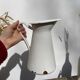 Old white enamelled metal pitcher