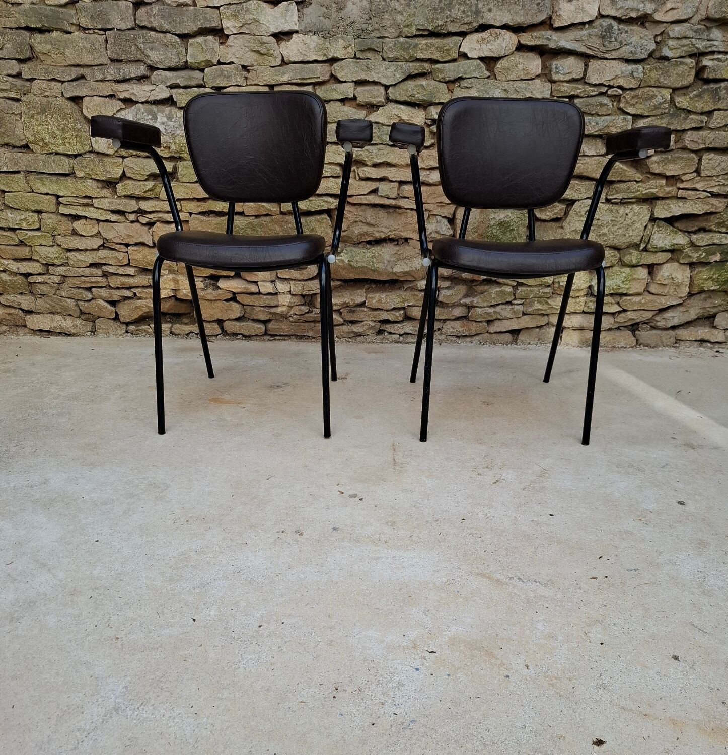 Brown faux leather armchairs