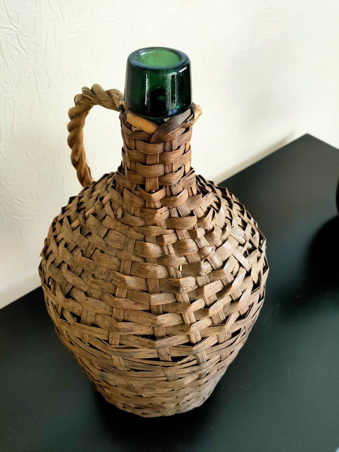 Antique demijohn made of glass and woven wicker