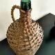 Antique demijohn made of glass and woven wicker