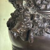 Patinated bronze vase with handles topped by bicéphalic busts, 19th century.