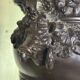 Patinated bronze vase with handles topped by bicéphalic busts, 19th century.