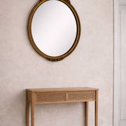 Antique oval mirror in Louis XVI style, gilded, with a bow pediment, 55cm.