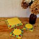 Yellow ceramic trivet and bottle coaster with vintage painted decoration.
