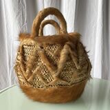 Handwoven vintage basket with handles made from natural fibres.