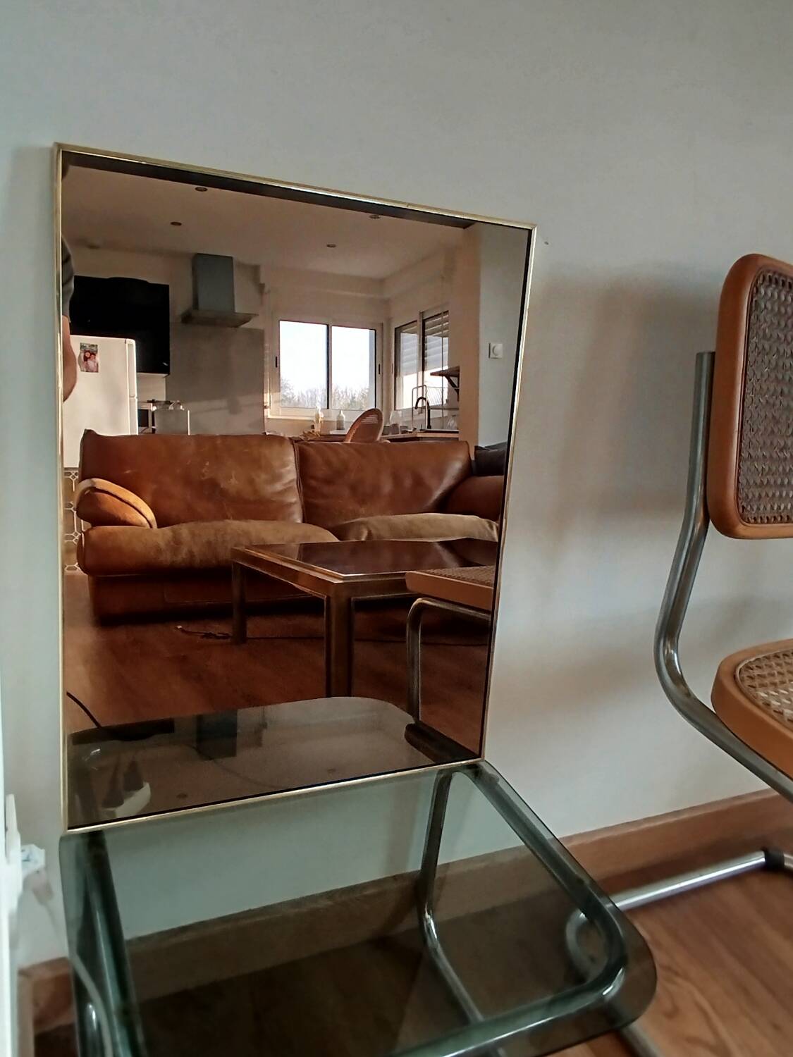 Vintage mirror in gilded brass and smoked glass. circa 1970