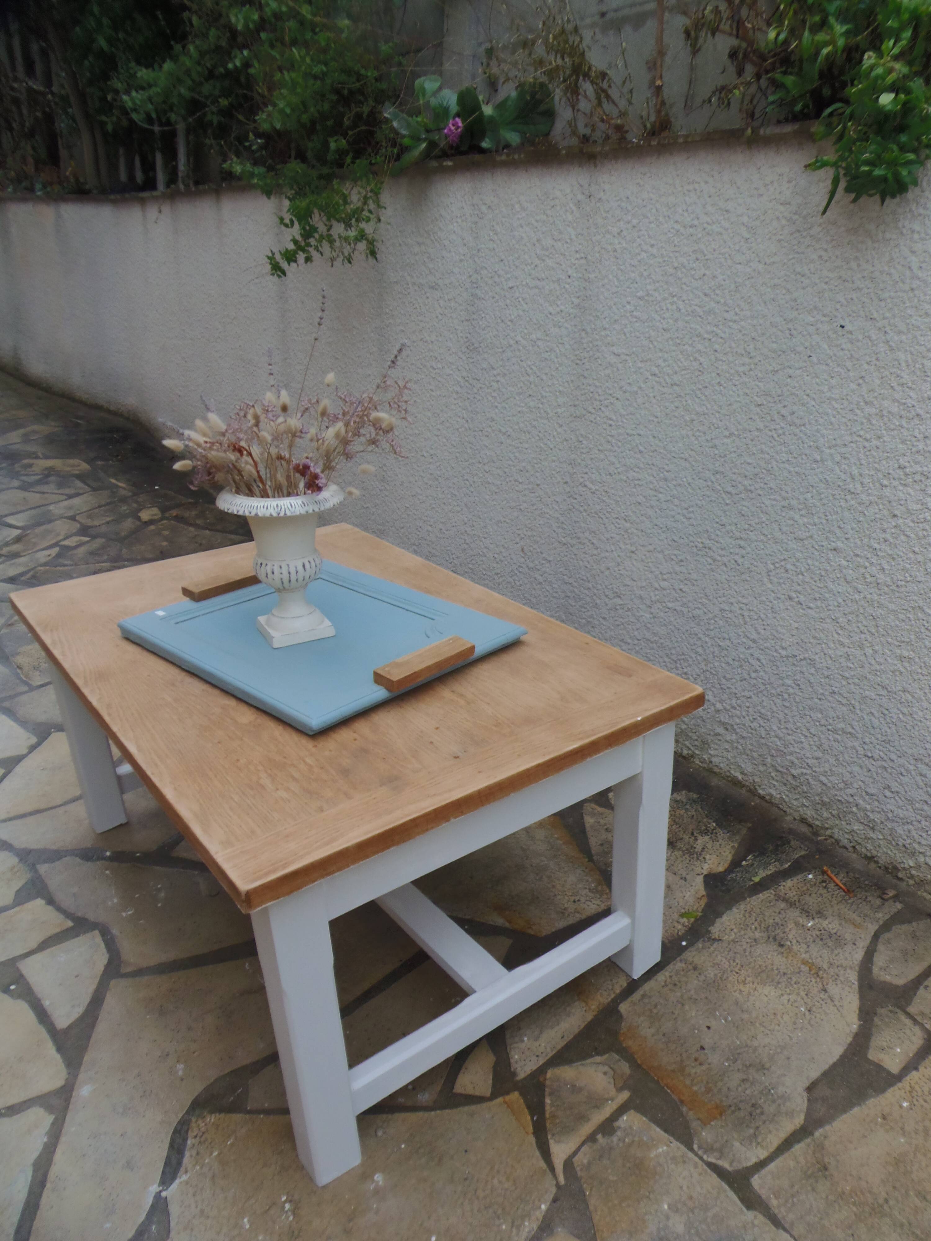 Coffee table with pearl grey legs and a wooden top.