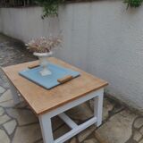 Coffee table with pearl grey legs and a wooden top.