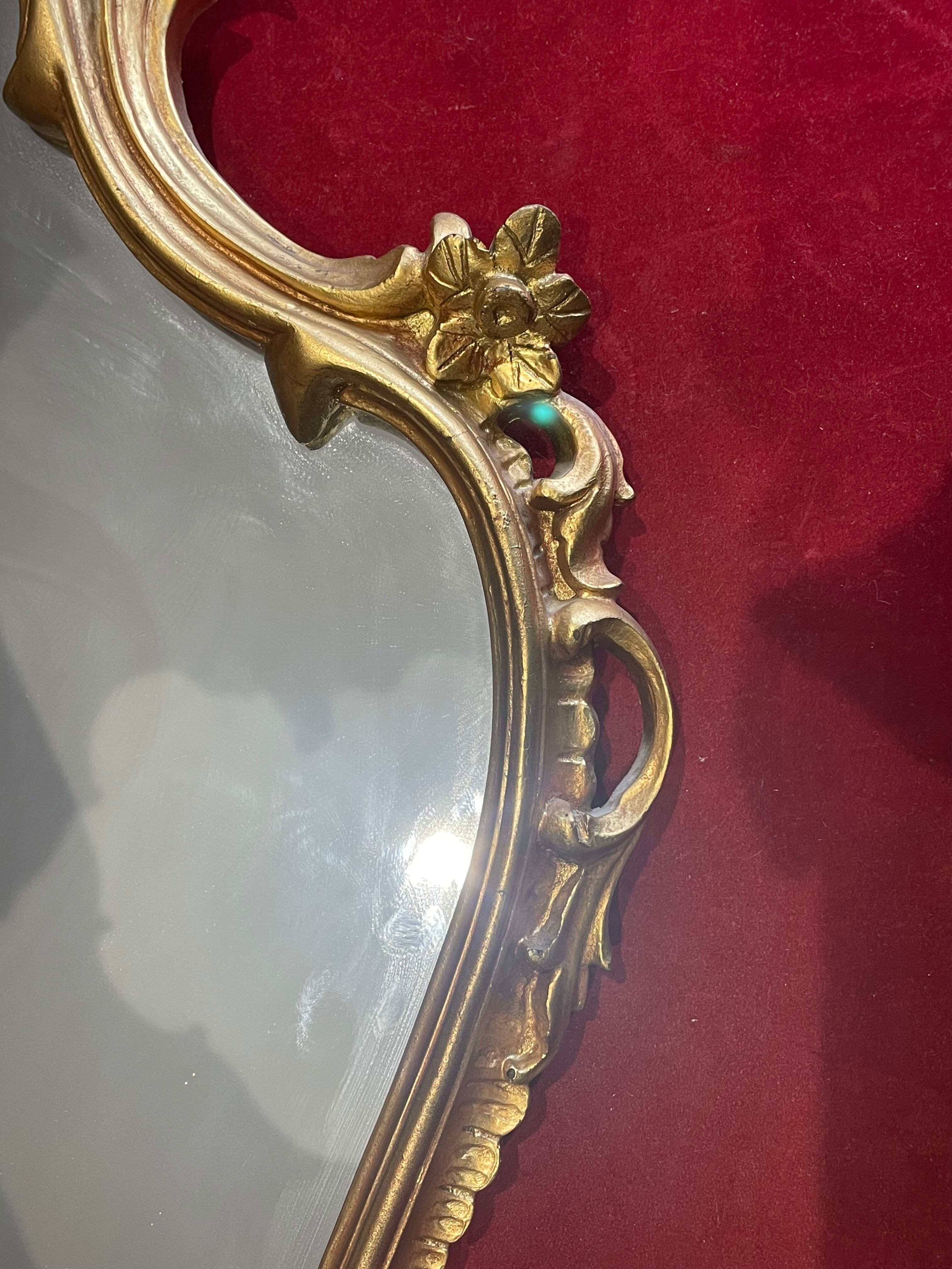 Louis XV Style wood and gilded stucco mirror with animated shape