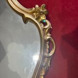 Louis XV Style wood and gilded stucco mirror with animated shape