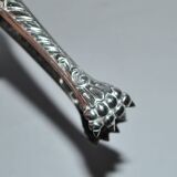 Rocaille sugar tongs in silver metal with lion claw medallion