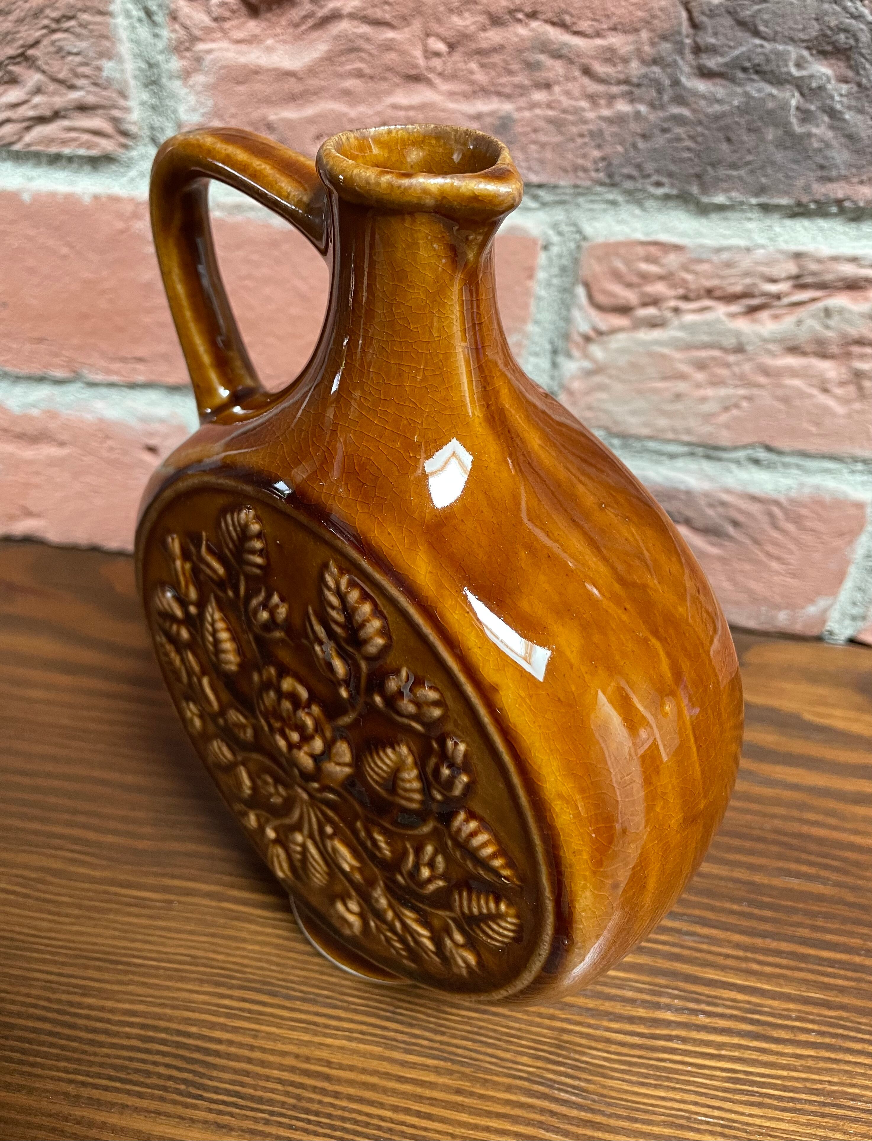 German round vase with floral motif, ornamental brown ceramic jug with handle