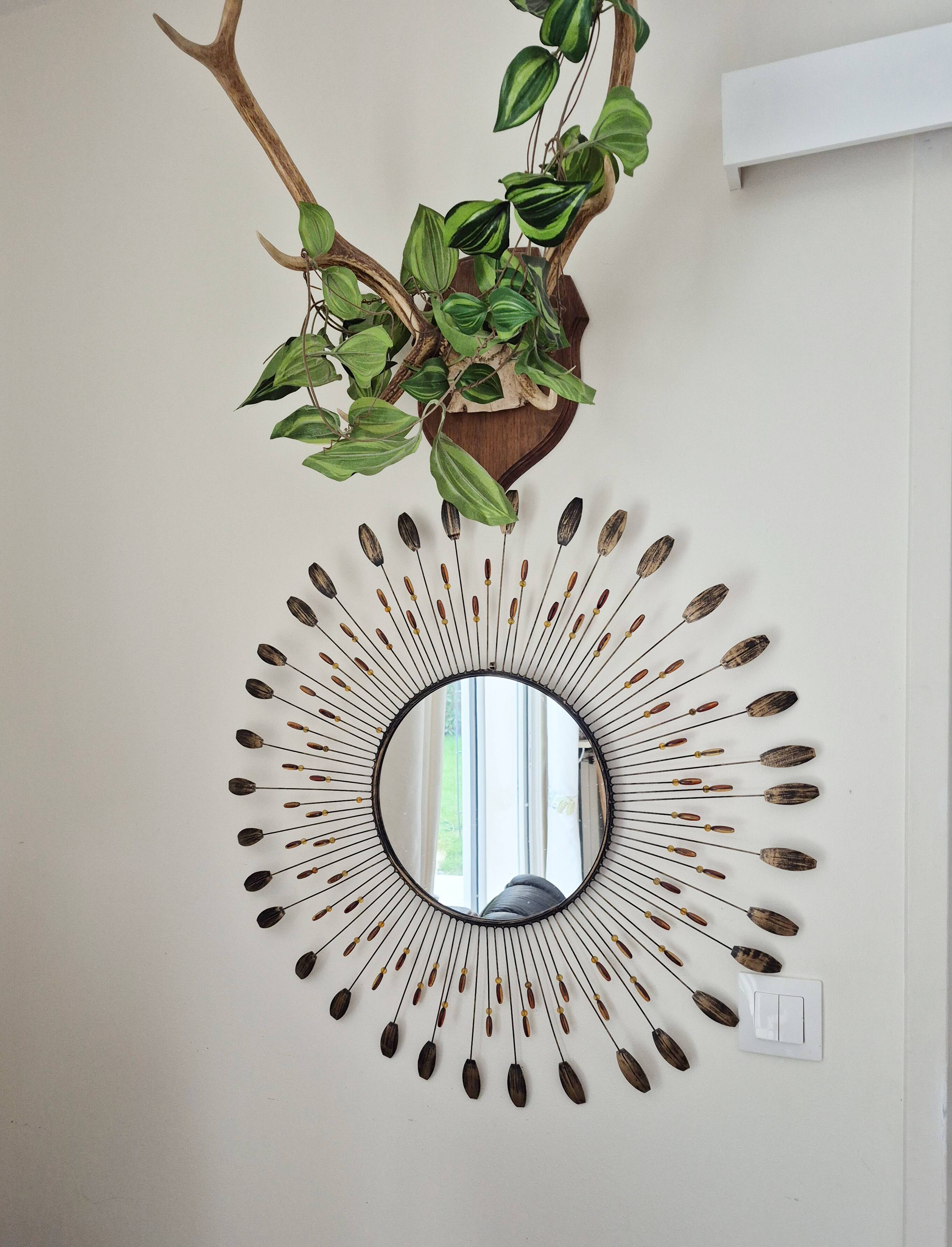 Vintage metal sun mirror in the style of Line Vautrin