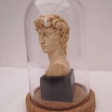 Small glass globe on base housing a figurine of “david”
