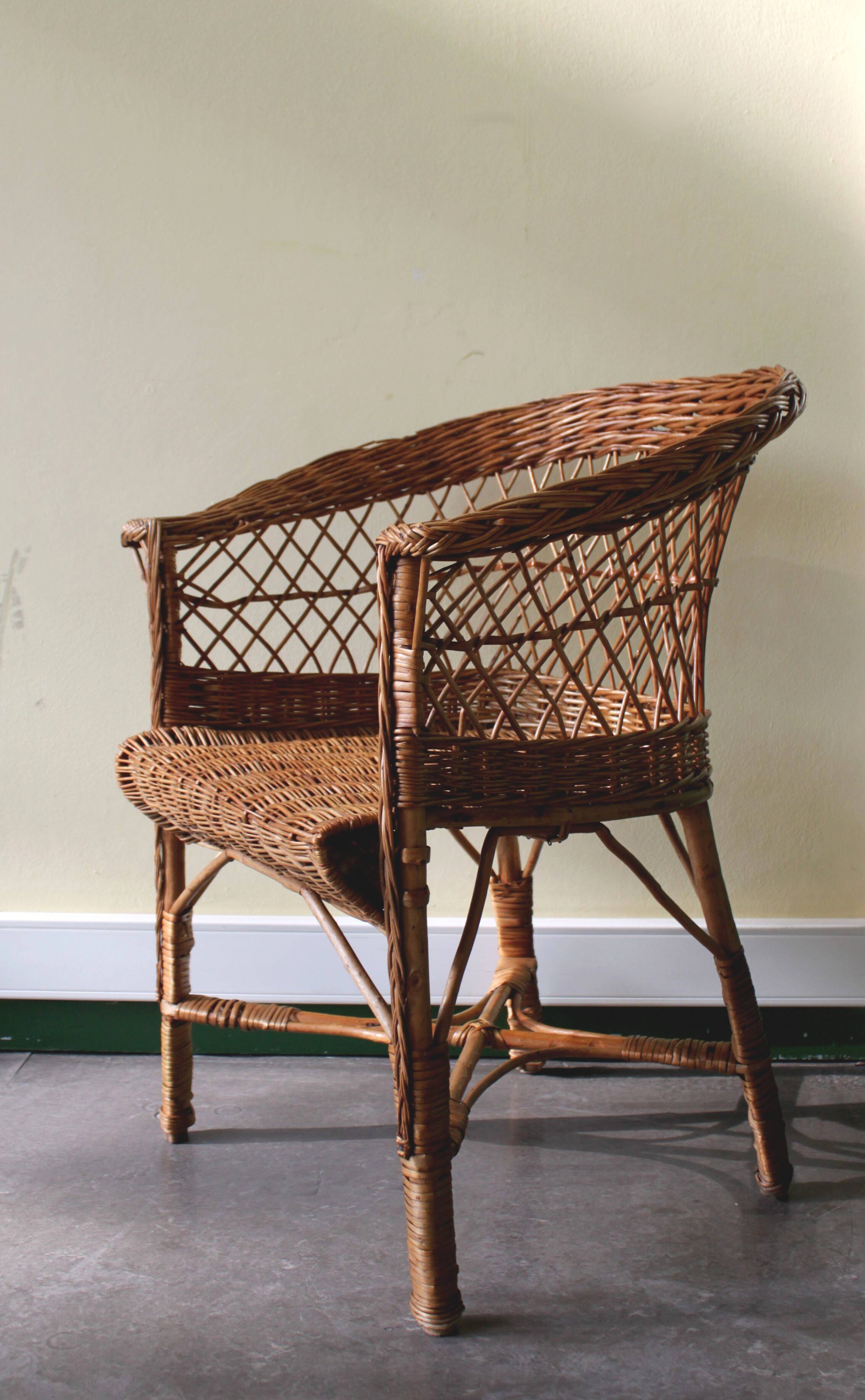 Woven rattan armchair with armrests.