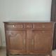 Two low antique buffets in carved solid oak with rosettes.