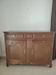 Two low antique buffets in carved solid oak with rosettes.